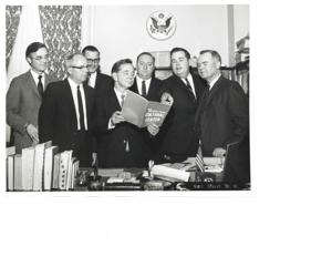 Carl Albert, Wes Watkins, and one other man with plaques and pictures concerning the Kiamichi Area Vocational Technical Schools., 1950-01-01 - 1976-12-31