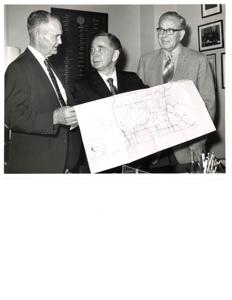 Carl Albert with a group of men in his office viewing a brochure in his office (probably same booklet as 3403)., 1950-01-01 - 1976-12-31