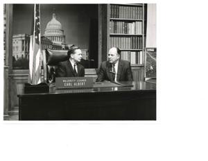 Carl Albert (right) looking at an Oklahoma travel brochure, Oklahoma Vacation Adventureland. A. S. Mike Monroney at left (in office)., 1960-01-01 - 1965-12-31