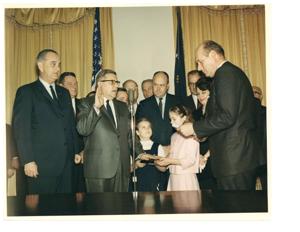 Attorney General Nicholas Katzenbach administering the oath of office to Postmaster General John A. Gronouski. February 19, 1965, 1965-02-19