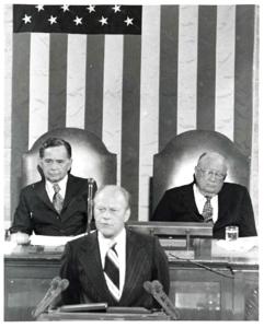 Gerald R. Ford standing at the speaker&#39;s podium. Carl Albert and James O. Eastland sitting behind him. Joint Session of Congress., 1950-01-01 - 1976-12-31
