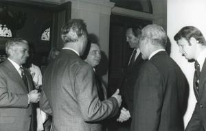 Carl Albert shaking hands with a man while others look on. This is during the House delegation trip to the USSR, Romania, and Yugoslavia. August 1975, 1975-08-04