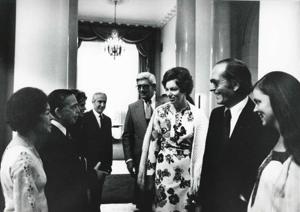Carl Albert speaking with an unidentified man and woman. Mary Albert is also present. House delegation trip. August 1975, 1975-08-04