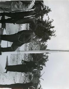 Carl Albert, Captain R. M. Hanson, and Mayor Harry Owens riding in a car in a parade in McAlester, Oklahoma on Armed Forces Day. 1968, 1968-01-01 - 1968-12-31