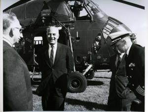 Carl Albert shown with military officers waiting for a helicopter to land. 1968, 1968-01-01 - 1968-12-31