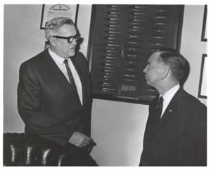 Carl Albert and unidentified people under a statue of Will Rogers., 1950-01-01 - 1976-12-31