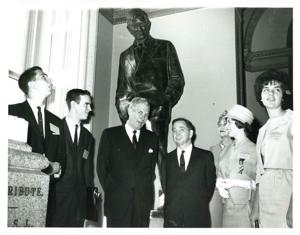 Carl Albert with a woman looking the book, Up From Slavery., 1950-01-01 - 1976-12-31