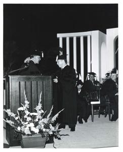 Carl Albert standing at a podium holding a recognition plaque., 1950-01-01 - 1976-12-31