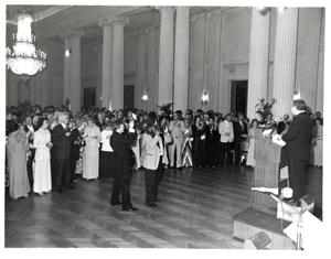 Carl Albert and Dewey F. Bartlett holding a book and shaking hands. American Revolution Bicentennial Ball in Oklahoma. October 2, 1976, 1976-10-02