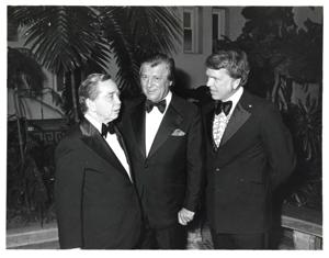 Dewey F. Bartlett, Carl Albert and Mary Albert, and Tom Steed are shown in a crowd of people apparently rendering a standing ovation to some performer or speaker at the American Revolution Bicentennial Ball in Oklahoma. October 2, 1976, 1976-10-02
