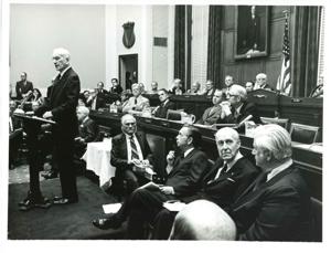 Carl Albert at the speaker&#39;s podium for the unveiling of Phil Philbin&#39;s portrait. Members of Congress are shown., 1970-01-01 - 1976-12-31