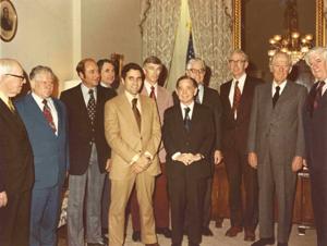 Man receiving a standing ovation in House chamber. Carl Albert standing behind speaker. Oversized, color., 1950-01-01 - 1976-12-31
