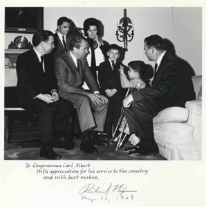 Large group of men in Oval Office observing Richard M. Nixon sign a bill. Carl Albert is shown. Color. July 1974 Oversized., 1974-07-01