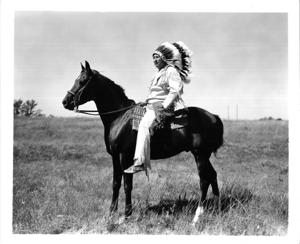 Collins Wahkinney, great-grandson of Quanah Parker, sitting on a horse in a pasture ca 1966, 1966-01-01 - 1966-12-31