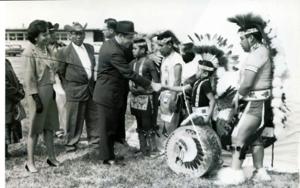 Fred R. and LaDonna Harris meets with American Indians (many in traditional dress) at the Shawnee Airport, 1963-01-01 - 1976-12-31