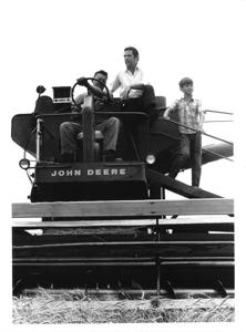Fred R. Harris riding a combine with Henry Jo VonTungel (operating the combine) and Dan VonTungel, 1970-06-01