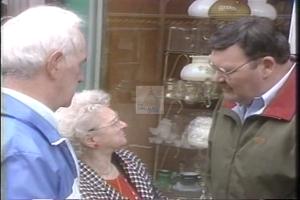 ["The 1994 campaign ad for Democratic Party candidate Duke DeTremble showcases his confident demeanor and leadership qualities through a series of scenes. These include him addressing enthusiastic crowds at rallies, engaging with supporters, and discussing policy plans, all against a backdrop of American flags and campaign banners emphasizing his dedication to defense, environment, and education. His promise of committed public service is evident throughout the advertisement."]